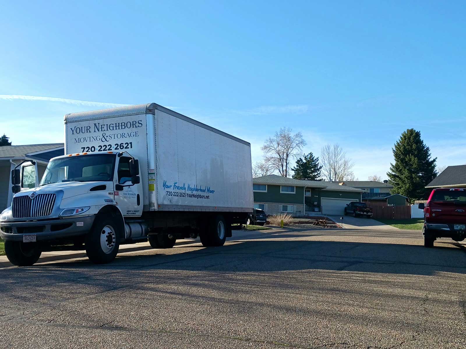 Your Neighbors moving truck on the road during Denver's busy summer moving season.