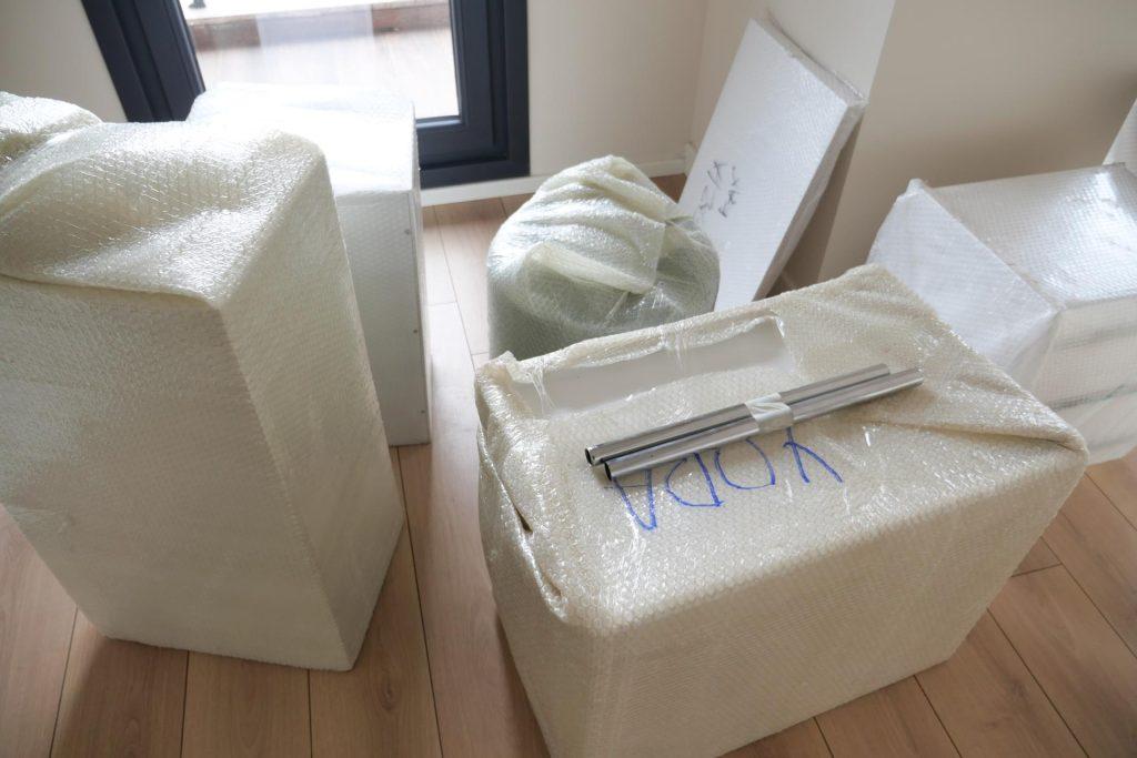 Unpacking Moving Boxes and Furniture in a New Home After a Recent Relocation Experience